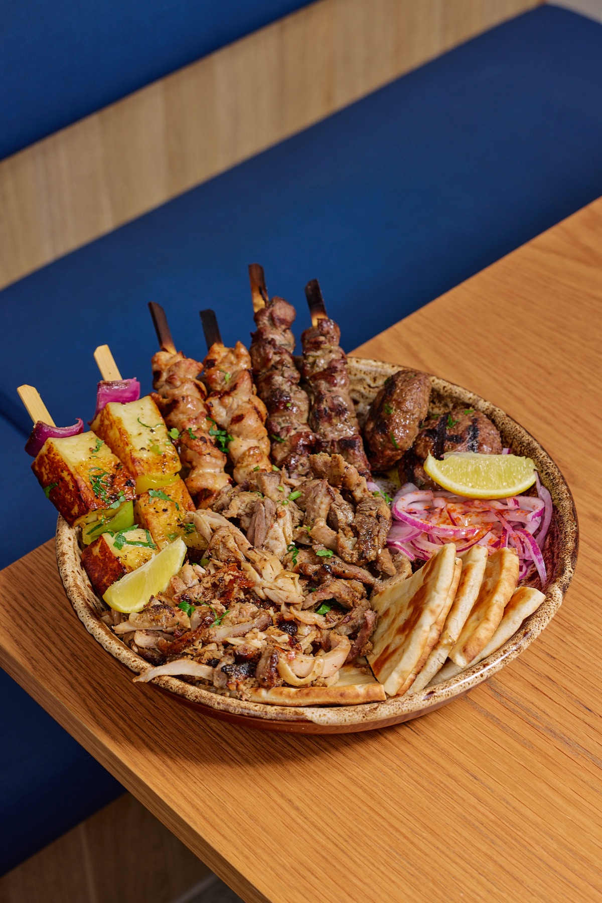 Yassas mixed grill platter with souvlaki, halloumi, kofta, gyros meat and pita bread