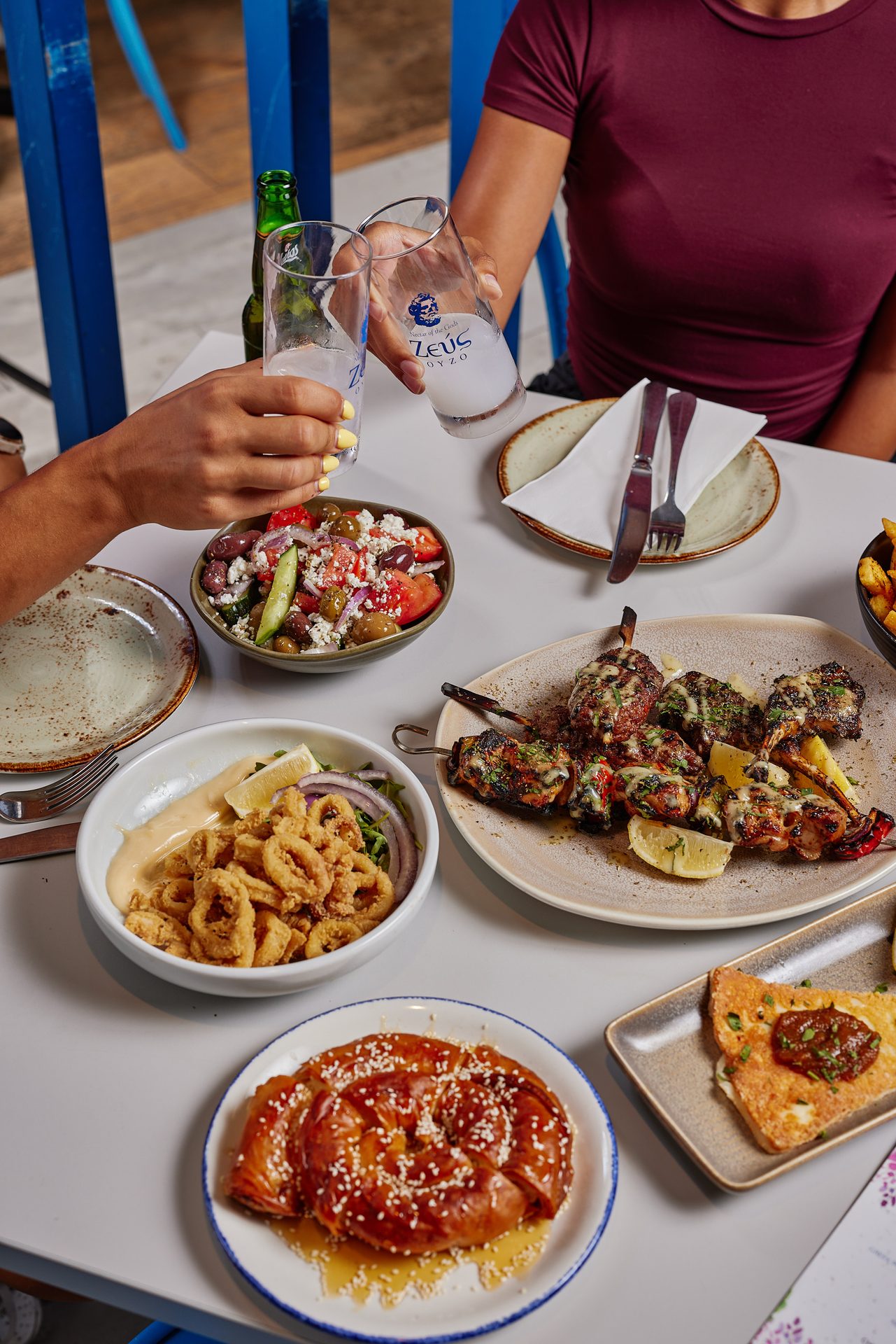 Greek feast spread at Yassas Docklands Melbourne — meze, souvlaki and charcoal grilled meats near Marvel Stadium